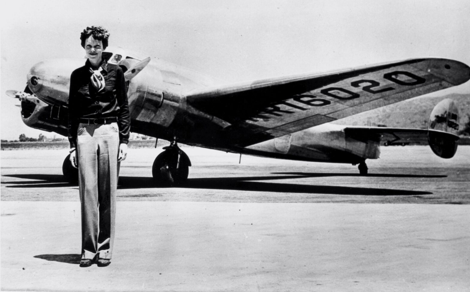 Amelia Earhart standing in front of the Lockheed Electra in July 1937.